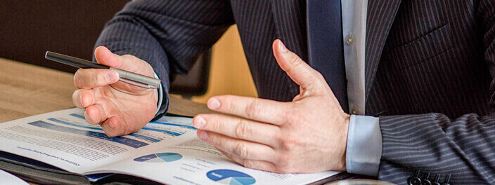 Close up of male hands on business document