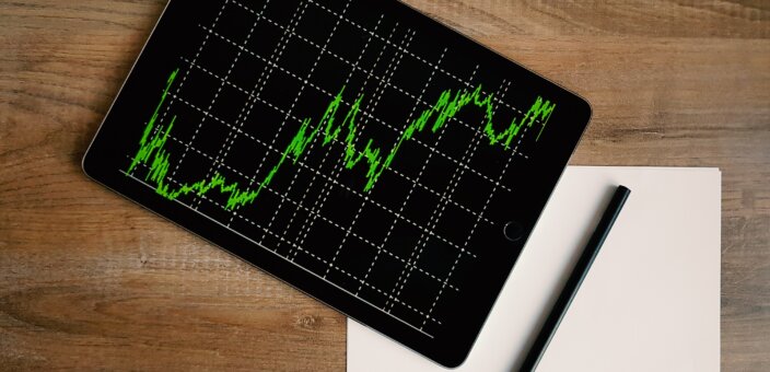space-grey-ipad-air-with-graph-on-brown-wooden-table-187041
