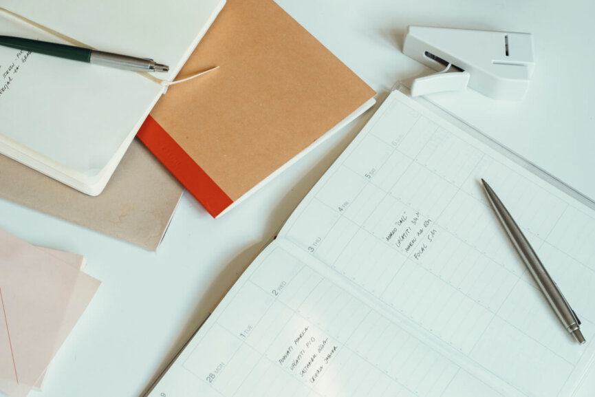 Image of Office Desk with Papers, Notebooks and Books