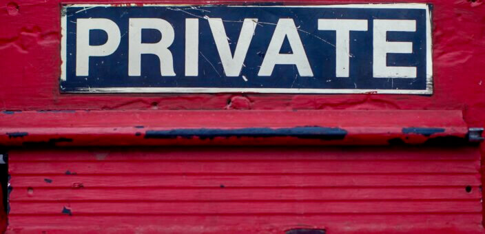 A red mail slot with a sign reading PRIVATE above it