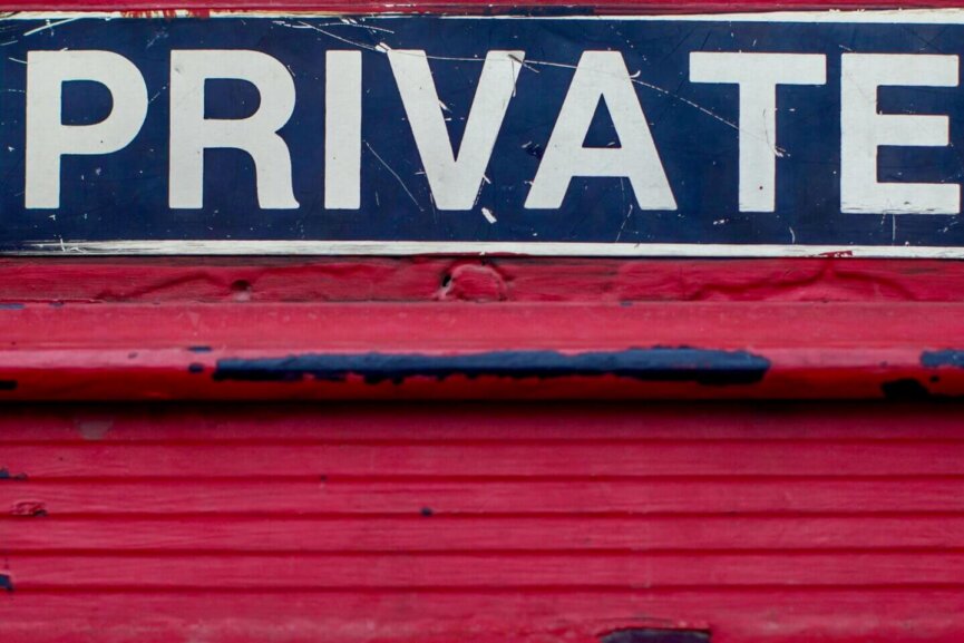 A red mail slot with a sign reading PRIVATE above it