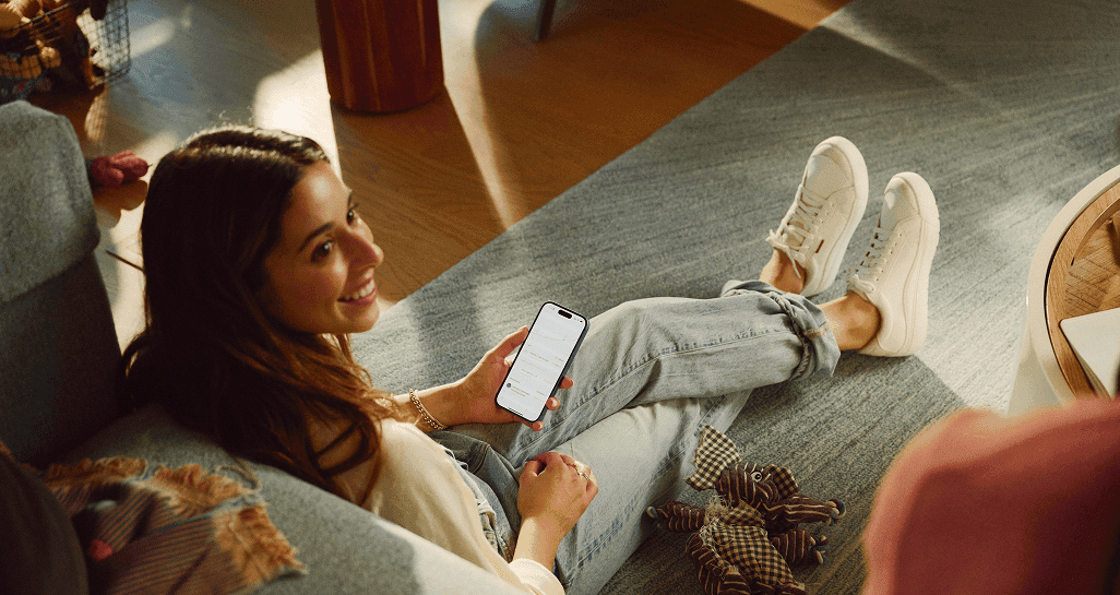 a woman sitting on a carpet in a den
